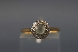A yellow and white metal zircon and diamond cluster ring. Stamped 18ct & PT. Size: L 2.