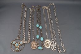 An assortment of white metal pendant and chains and necklaces with synthetic turquoise.