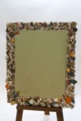 A decorative rectangular wall mirror decorated with seashells to the border, bevelled glass,