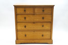 A Victorian beech chest of two short over three drawers with ecclesiastical design brass handles,