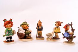 Five Goebel Hummel figures including a red headed girl holding a bunch of flowers
