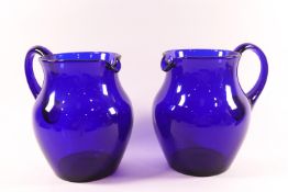 A pair of Bristol blue glass jugs,