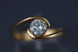 A yellow metal single stone diamond ring. Stated as 1.