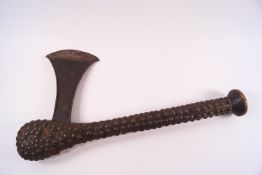 An African axe with wooden brass studded handle,