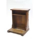 A small Victorian oak lectern with under-shelf and panel front,