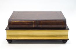 A modern leather covered book coffee table, the top with 'tooled' effect gold decoration,