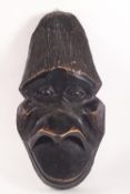 An African tribal wall mask, carved as an ape,