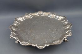 A George II silver salver, with shell and scroll cast rim, chased with flowers and C scrolls,