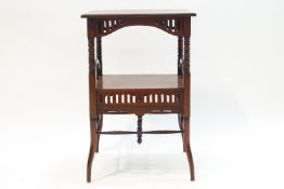 A Victorian mahogany two tier square occasional table with pierced apron and turned supports,