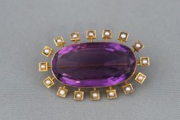 An oval amethyst and seed pearl cluster brooch. Pin and C catch fitting. Tests indicate 18ct gold.