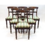 A set of six William IV mahogany dining chairs with scroll carved backs,