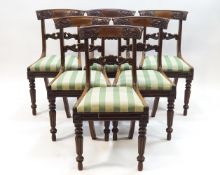 A set of six William IV mahogany dining chairs with scroll carved backs,