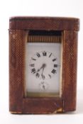 A small French brass carriage clock, the enamel dial with Roman numerals and five minute markers,