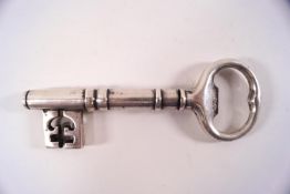 An early 20th century silver plated key corkscrew bottle opener, with a steel spiral worm,