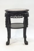 A Chinese carved hardwood table with inset marble top,