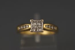 A yellow and white metal princess cut diamond ring with diamond shoulders. Stated total weight as 0.