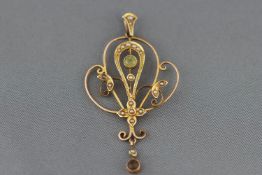 An Edwardian yellow metal peridot and seed pearl pendant. Stamped 9ct. 2.