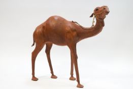A floor standing leather figure of a camel,