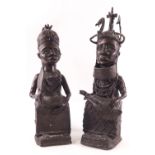 A pair of African tribal bronzes of seated women, one fanning herself,