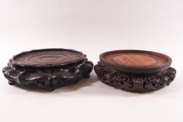 A large Chinese carved hardwood vase stand, 24cm diameter and another stand, carved and pierced,