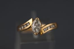 A yellow metal ring set with a marquise cut diamond stated as 0.72ct.