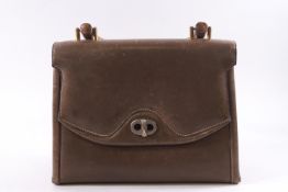 A Gucci taupe ladies handbag with beech handle and brass fittings,