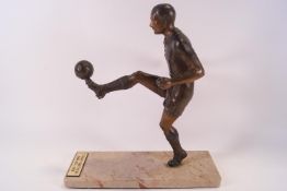 A bronze effect sculpture of Stanley Matthews on a marble base