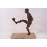 A bronze effect sculpture of Stanley Matthews on a marble base