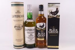 A bottle of Laphroaig single malt whisky and a bottle of Black Grouse blended whisky