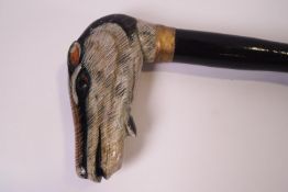 A walking stick with a Badger's head knop