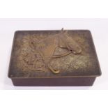 A rectangular wooden box with a horses head and riding motifs in relief,