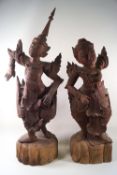 A pair of carved Balinese figures of dancers, in traditional costume, 65cm high,