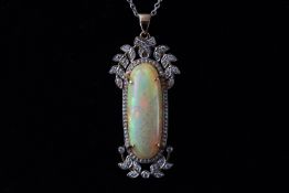 A yellow and white metal foliate design pendant set with a cabochon orange opal measuring 24.