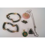 A collection of Chinese hardstone jewellery, comprising of two bangles and four pendants,