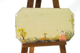 A 1930's wall mirror, painted with a lady in a landscape,