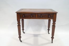 A Victorian mahogany writing table with leather inset top above two drawers with turned handles on