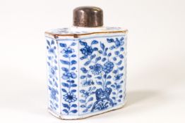 A Chinese porcelain tea caddy with white metal cover, painted in underglaze blue with flowers,