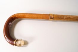 A bamboo shafted walking stick with brass mounts and ivory tip