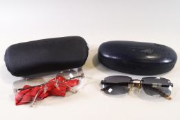 A pair of Chanel sunglasses, cased, and a pair of Burberry sunglasses,