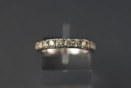 A white metal thirteen stone half hoop ring. Stated weight as 0.93ct.