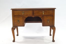 A Ladies mahogany writing desk, with an arrangement of four drawers on cabriole legs,