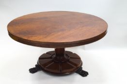A William IV mahogany breakfast table, the tilt top on octagonal pedestal,
