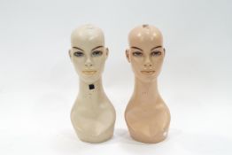 Two shop mannequin heads with spray painted features,