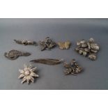 Eight white metal and marcasite brooches, of various designs, some stamped "silver" and "925",