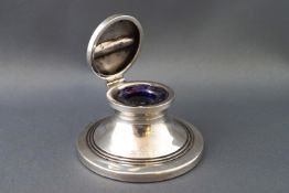 A silver inkwell,