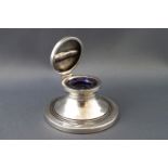 A silver inkwell,