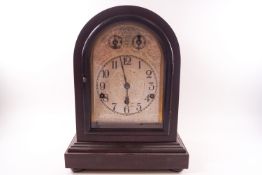 A 20th century German chiming mantel clock with strike/silent and fast/slow dial in domed mahoagny