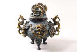 A Japanese bronze patinated koro and cover with two dragon handles on three paw feet,