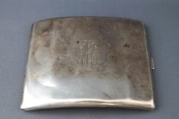 A white metal cigarette case, of curved form engraved with a monogram, possibly Russian, 6cm x 9.