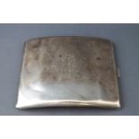 A white metal cigarette case, of curved form engraved with a monogram, possibly Russian, 6cm x 9.